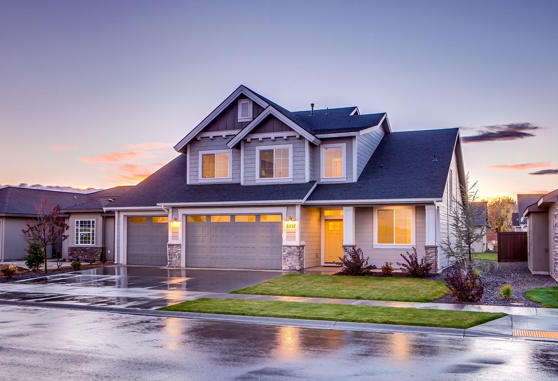 Blue and gray craftsman-style home at twilight